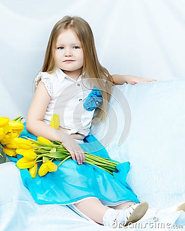 Little girl with bouquet of tulips Stock Photo