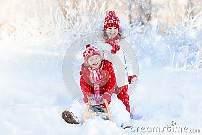 Kids play in snow. Winter sleigh ride for children Stock Photo