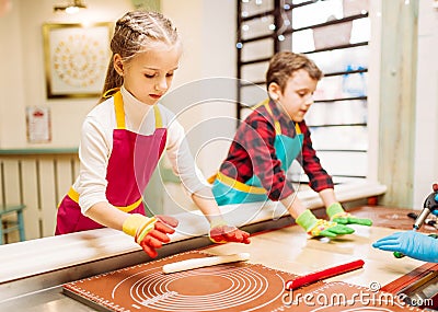 Little girl and boy learn to make caramel Stock Photo