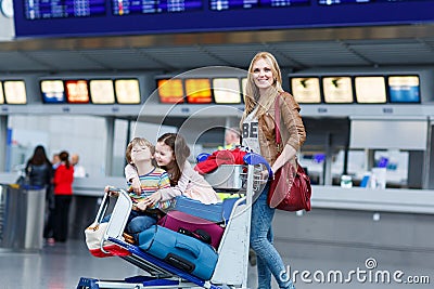 Little girl and boy and young mother with suitcases on airport Stock Photo