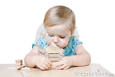 Little girl building toy house Stock Photo