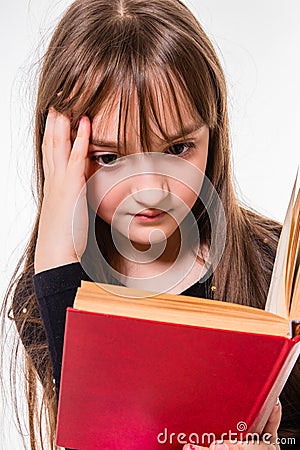 Little girl carefully reading a book Stock Photo