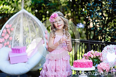 Little girl celebrate Happy Birthday Party with rose outdoor Stock Photo