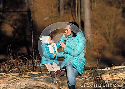 Little girl child lipstick itself and mom. Stock Photo