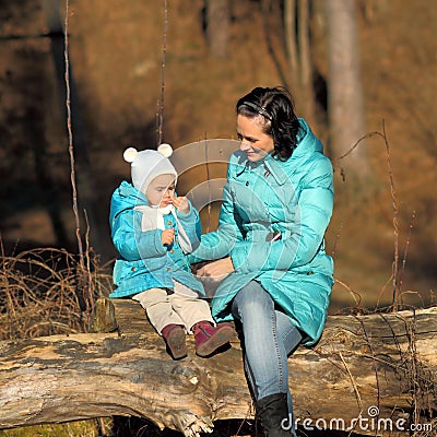 Little girl child lipstick itself and mom. Stock Photo