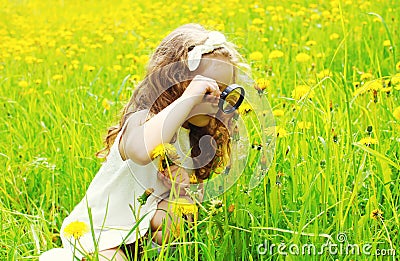 Little girl child looking through a magnifying glass Stock Photo