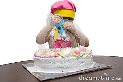 Little girl children decorate cream cake Stock Photo