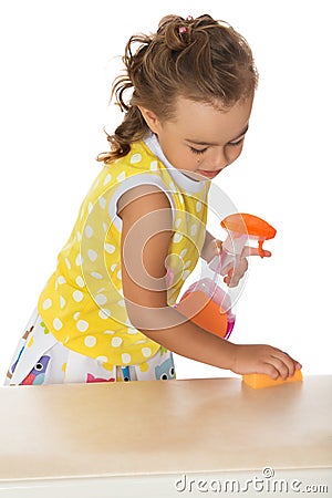 Little girl cleans the table Stock Photo