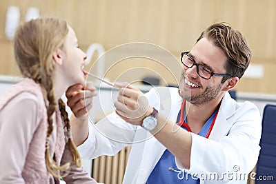 Little girl in clinic having a checkup with laryngologist Stock Photo