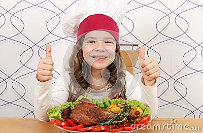 Little girl cook with big drumstick and thumbs up Stock Photo
