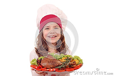 Little girl cook with big turkey drumstick and vegetables Stock Photo