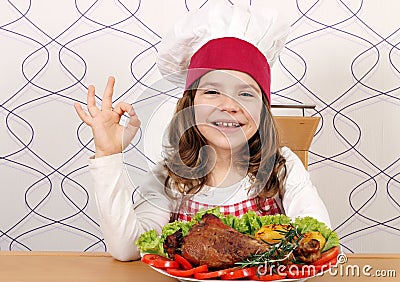 Little girl cook with drumstick and ok hand sign Stock Photo