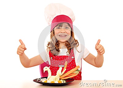 Little girl cook with thumbs up and white swan decorated s Stock Photo