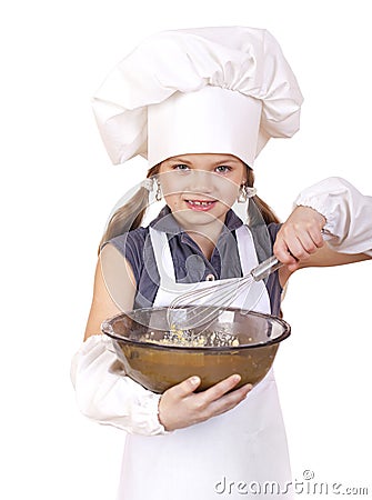 Little girl cook whips whisk eggs in a large plate Stock Photo
