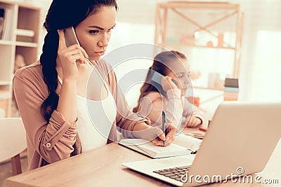 Little Girl Copies Mom with Phone in Hand at Home. Stock Photo