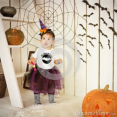 Little girl in costume Halloween witch on a holiday Stock Photo