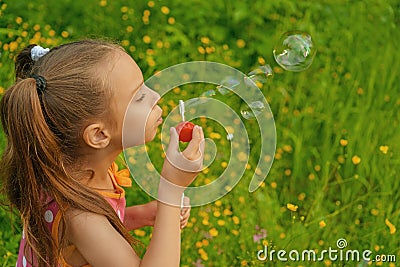 Little girl creates bubbles Stock Photo