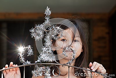 Little girl decorates the gate of the house Stock Photo