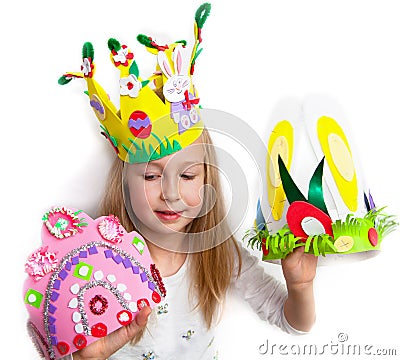 Little girl demonstrating her craft works, Easter bonnets Stock Photo