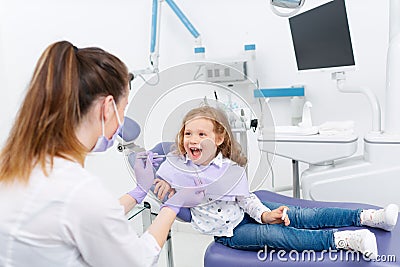 Little girl in dentist chair Stock Photo