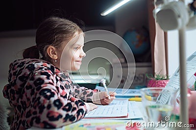 little girl at distance home schooling, study lessons on quarant Stock Photo
