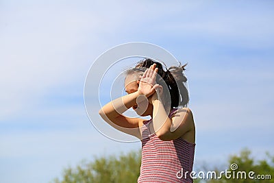 The little girl does not want to be photographed Stock Photo