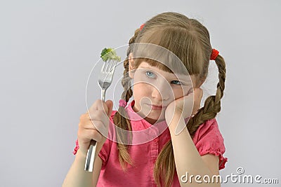 Little girl does not want to eat broccoli Stock Photo