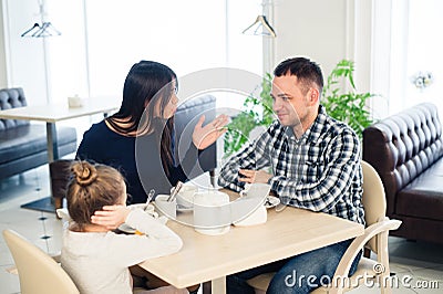 Little girl doesn`t want to hear arguing of parents Stock Photo