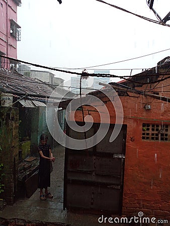 A little girl doing fun with raining Editorial Stock Photo