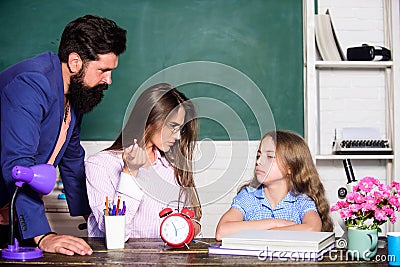 Little girl doing homework. Dad mom teaching child. Intelligent family. Greatest drawback overprotective parenting style Stock Photo