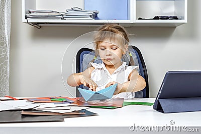 Little girl is doing origami with the teacher online Stock Photo