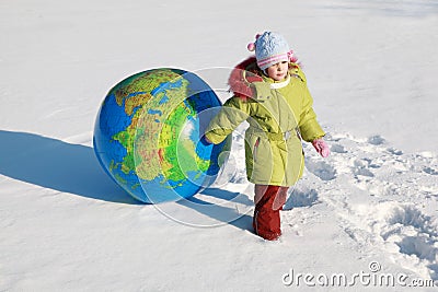 Little girl drags big inflatable globe Stock Photo