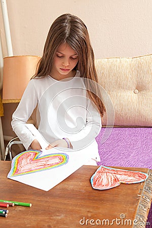 Little Girl is Drawing Colorful Hearts Stock Photo