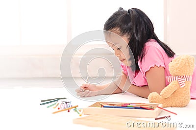 Little girl drawing at home for quarantine durin coronavirus. Kids playing alone at home Stock Photo