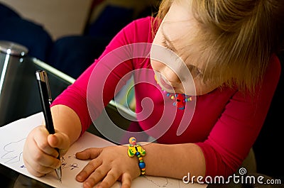 Little girl drawing with pen Stock Photo