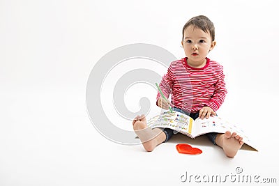 Little girl draws sitting on the floor isolated on white Stock Photo