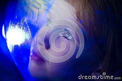 girl dreams of becoming astronaut and flying into space. reflection of planet Stock Photo