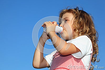 Little girl drinks yoghurt from small bottle Stock Photo