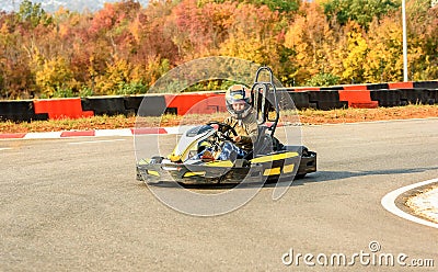 Little girl is driving Go- Kart car in a playground racing track Stock Photo