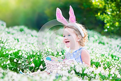Little girl at Easter egg hunt Stock Photo