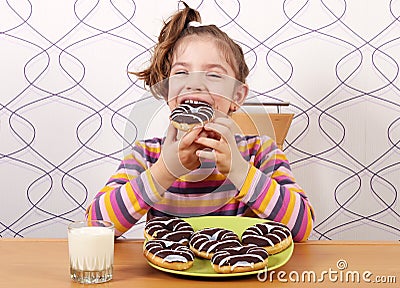 Little girl eat chocolate donuts Stock Photo