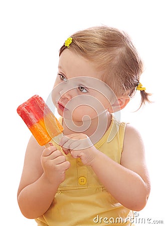 Little girl eating colorful ice lolly Stock Photo
