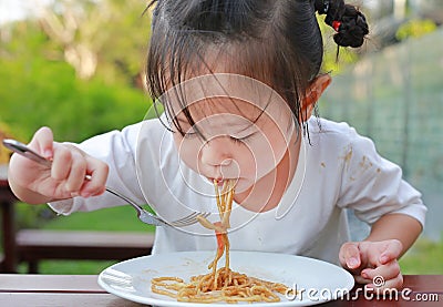 Little girl eating Japanese yakisoba noodles Stock Photo