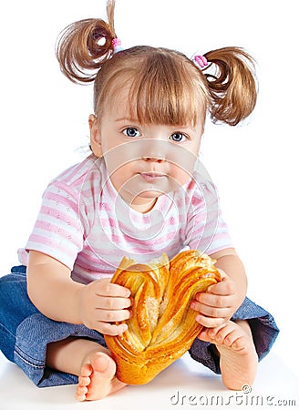 Little girl eating a loaf of bread Stock Photo