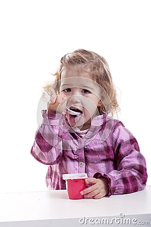 Little girl eating youghurt. Stock Photo