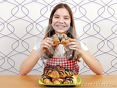 Little girl eats tasty croissant with chocolate Stock Photo