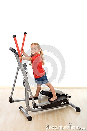 Little girl on elliptical trainer Stock Photo