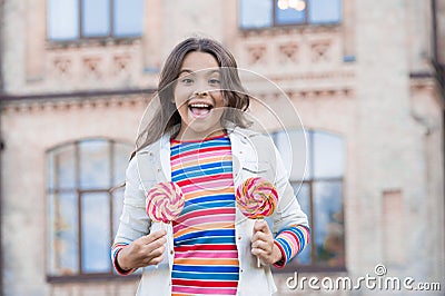 Little girl enjoy summer vacation eat sweets, caramel lollipop concept Stock Photo