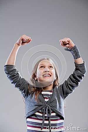 Little girl exulting raising her arms Stock Photo