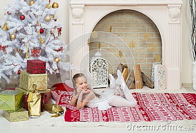 Little girl in fairy pixi costume dress is posing beside the Christmas tree Stock Photo